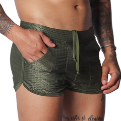 Olive green mesh athletic shorts with a drawstring waist, side pockets, and a short-cut curved hem.