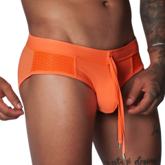 Bright orange swim brief with mesh side panels, an elastic waistband, and a decorative front drawstring tie.
