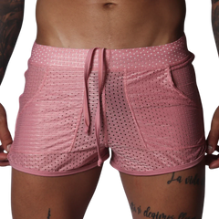 Pink mesh athletic shorts with a drawstring waistband, two side pockets, and a shorter, fitted cut.