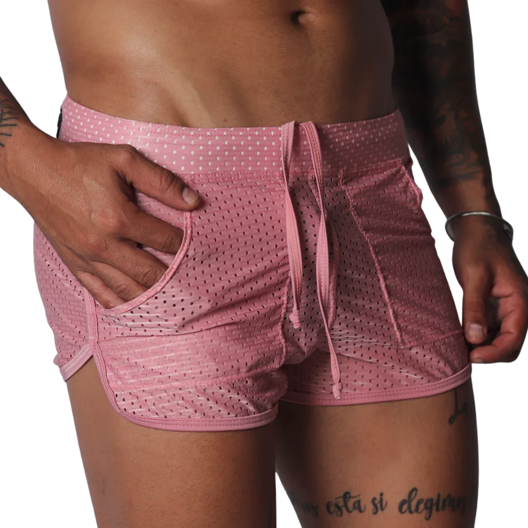 Pink, mesh athletic shorts with a drawstring waistband, side pockets, and curved hem detail.