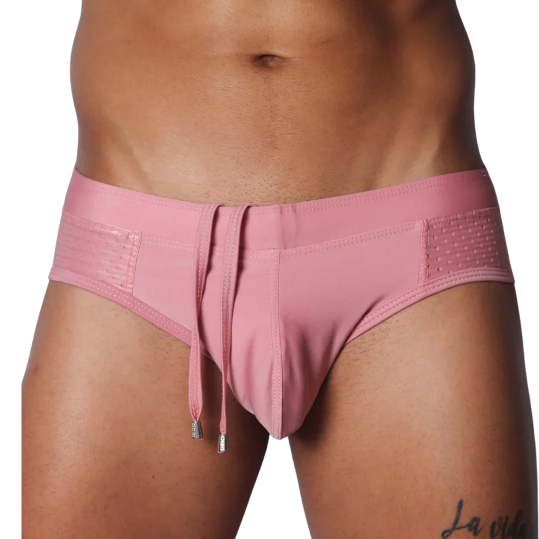 Dusty pink swim brief with a smooth center, side mesh panels, and hanging decorative drawstrings with silver tips.