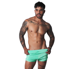 Gigo Flash Green short, a fitted, mid-thigh length lounge short in a bright, shimmering mint-green fabric.