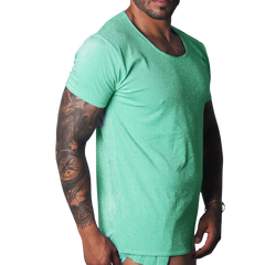 Flash green scoop-neck t-shirt with a metallic, shimmering finish worn by a tattooed man.