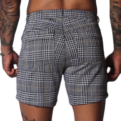 Black and white houndstooth print shorts with a subtle gold windowpane check pattern and two rear pockets.
