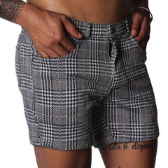 Men's slim-fit shorts in a black and white houndstooth glen plaid pattern with subtle gold thread accents.