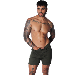 Slim-fit forest green cotton shorts featuring a mid-thigh length, button fly, and classic five-pocket design.