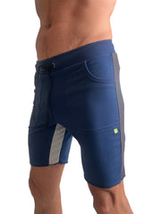 Tri-color ultra-flex yoga track short in navy blue with gray side panels and green logo designed for athletic use