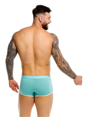Back view of a man wearing mint green trunks with white trim featuring a fitted cut by JOR brand