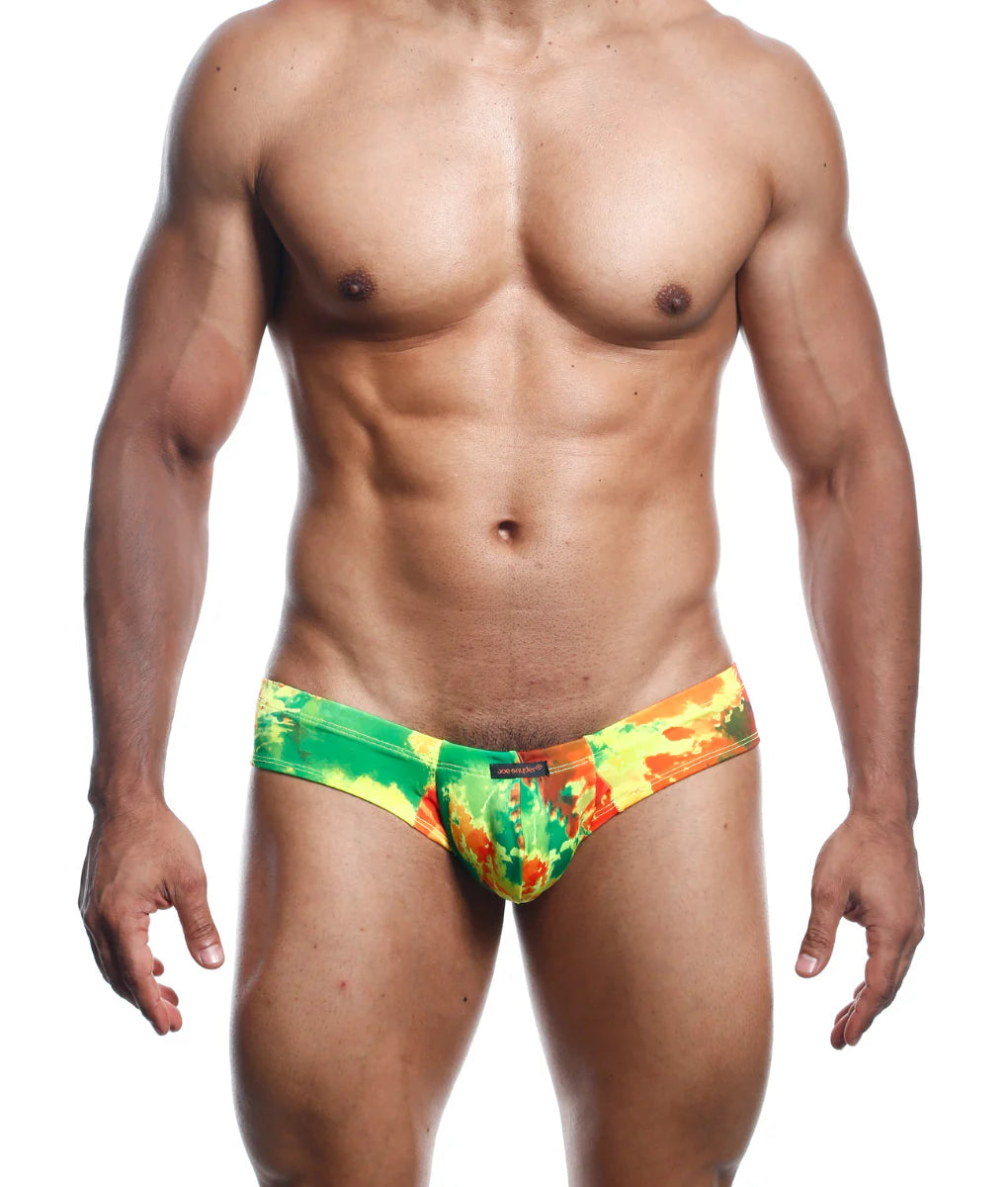 Joe Snyder mini cheek swim trunks with vibrant green and orange tie dye and bold abstract pattern