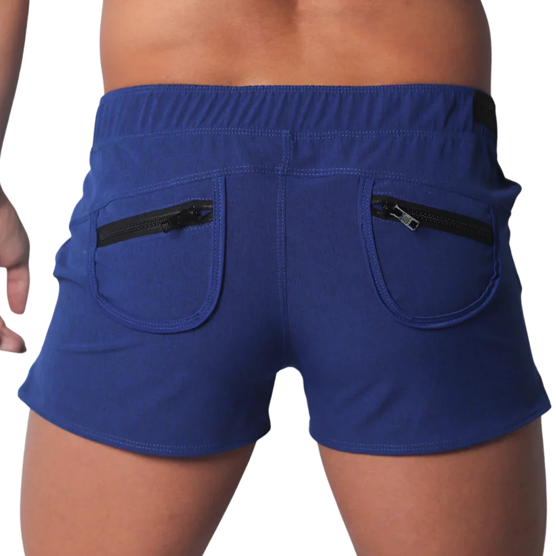 Royal blue short-length men’s athletic shorts with an elastic waistband and two back pockets featuring black zippers.