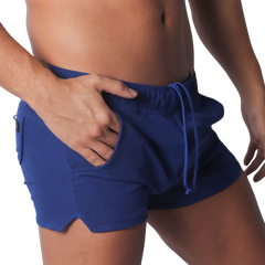 Royal blue fitted athletic shorts with an elastic drawstring waistband, side pockets, and small side leg slits.