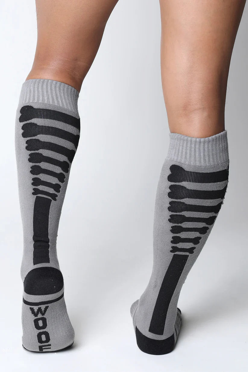 Gray knee-high socks with black skeletal design and wood printed on the heel in kennel club bones collection