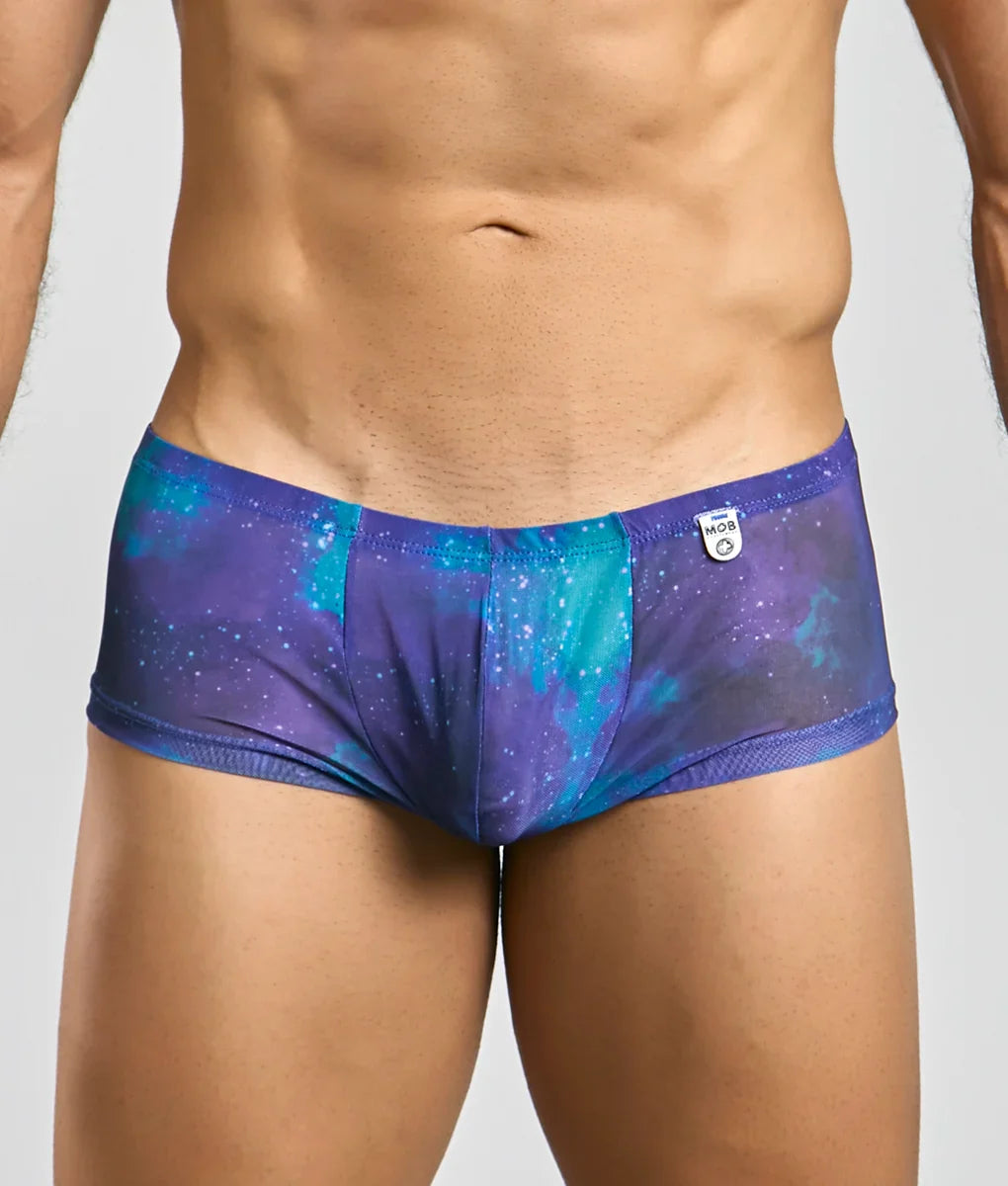 Mob men’s sexy sheer hip brief in purple and teal galaxy pattern with mesh trim designed for a bold look