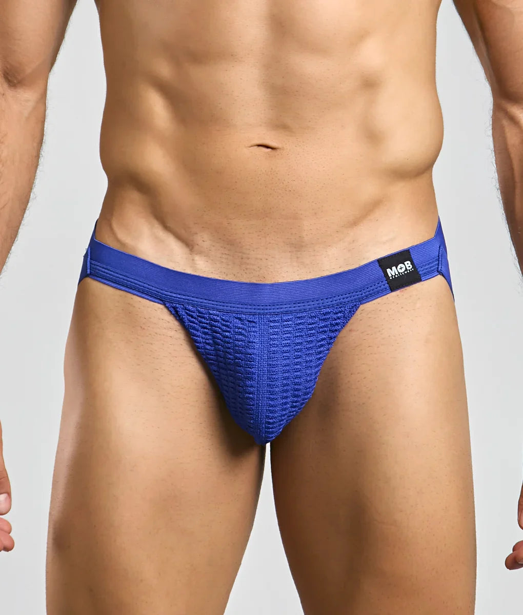Blue textured athletic swim jockstrap with black mob brand tag on waistband designed for performance use
