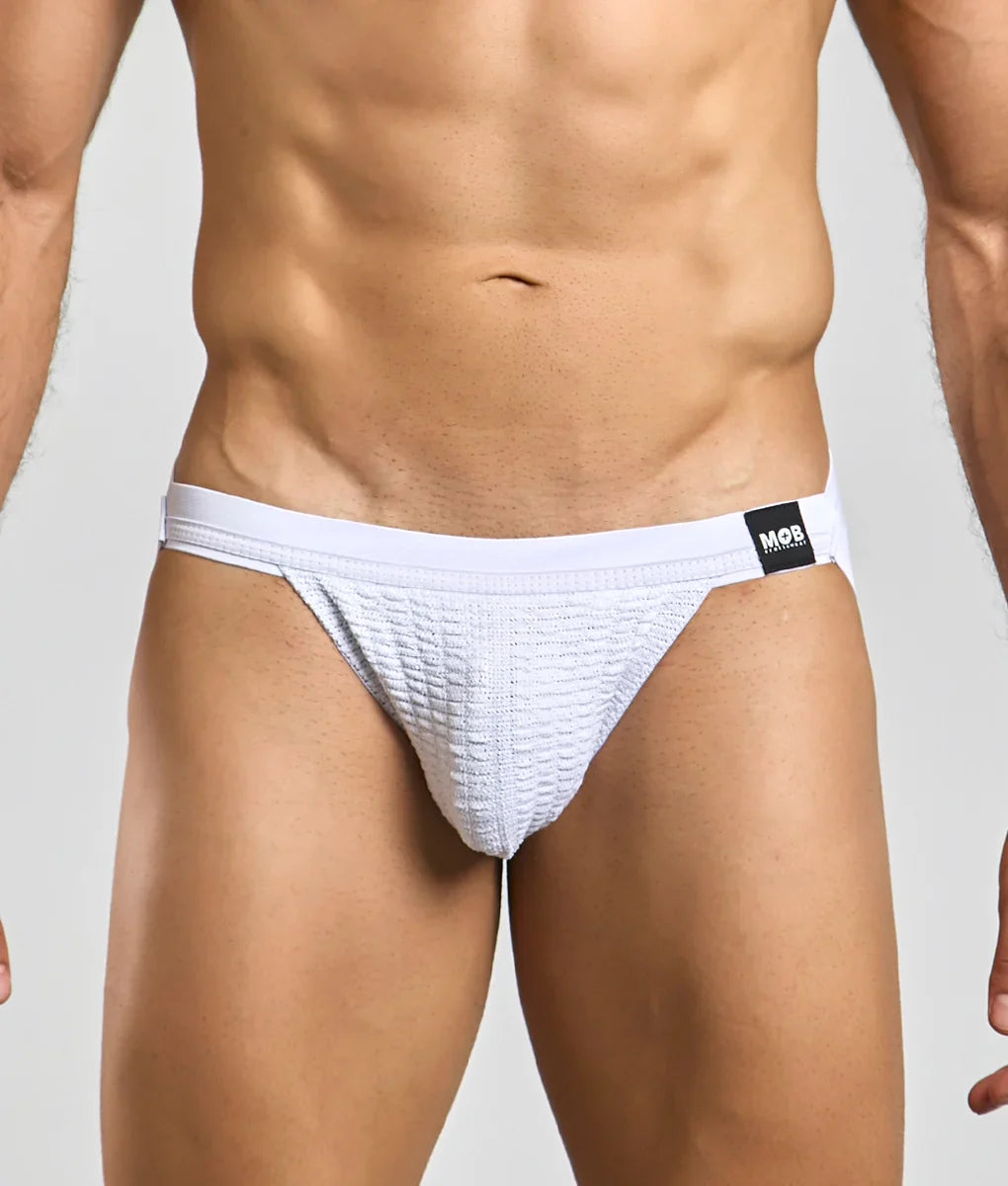 White textured briefs with a black mor brand tag on the waistband for mob swim jockstrap