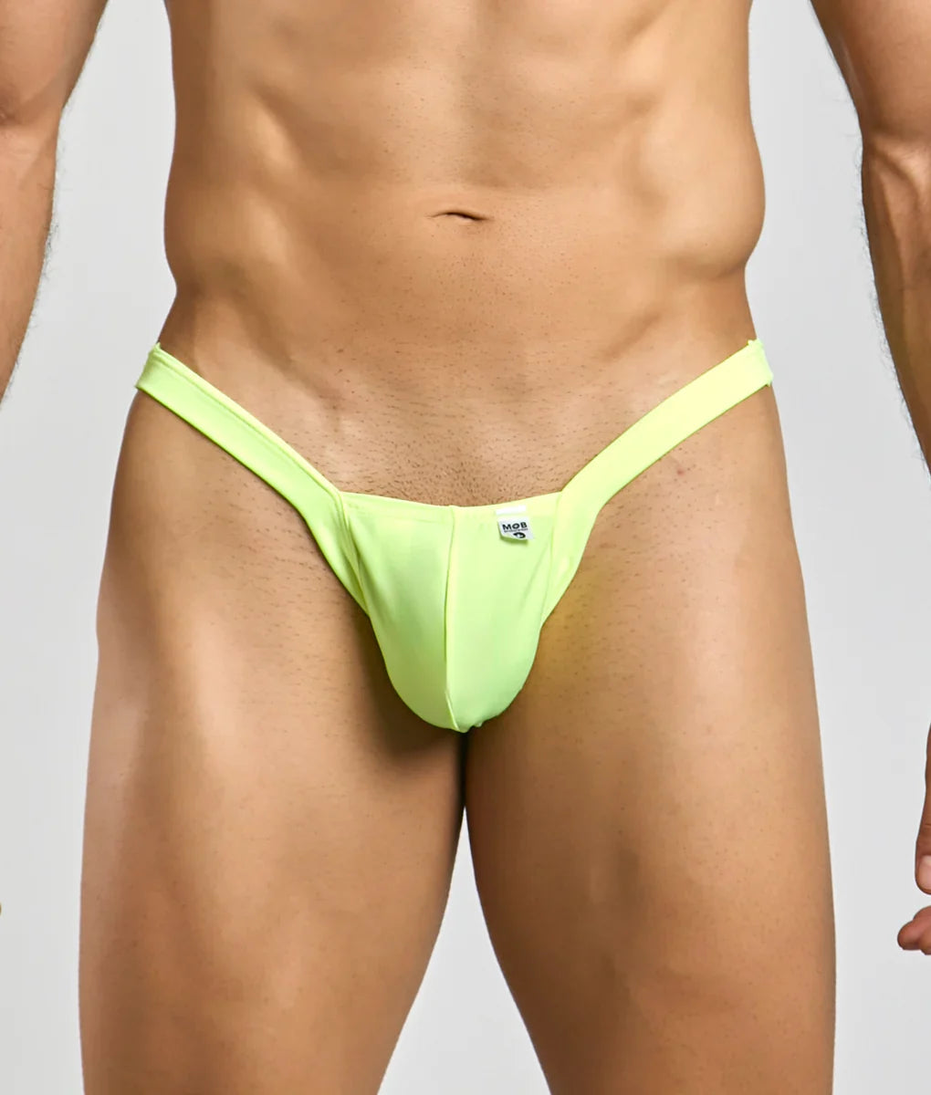Bright neon green mob y buns thong made of smooth stretchy fabric with a small white brand tag at the center