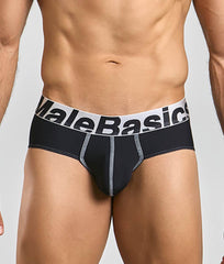 Black malebasics microfiber brief with white waistband, bold black lettering, and silver stitching along seams