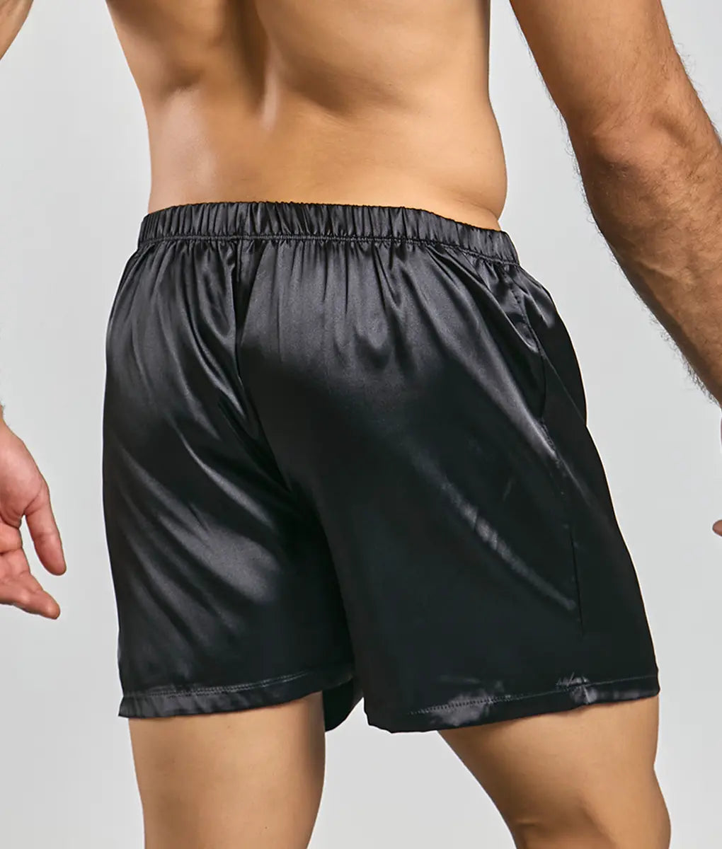 Black satin shorts from malebasics featuring a smooth glossy finish and elastic waistband for comfort