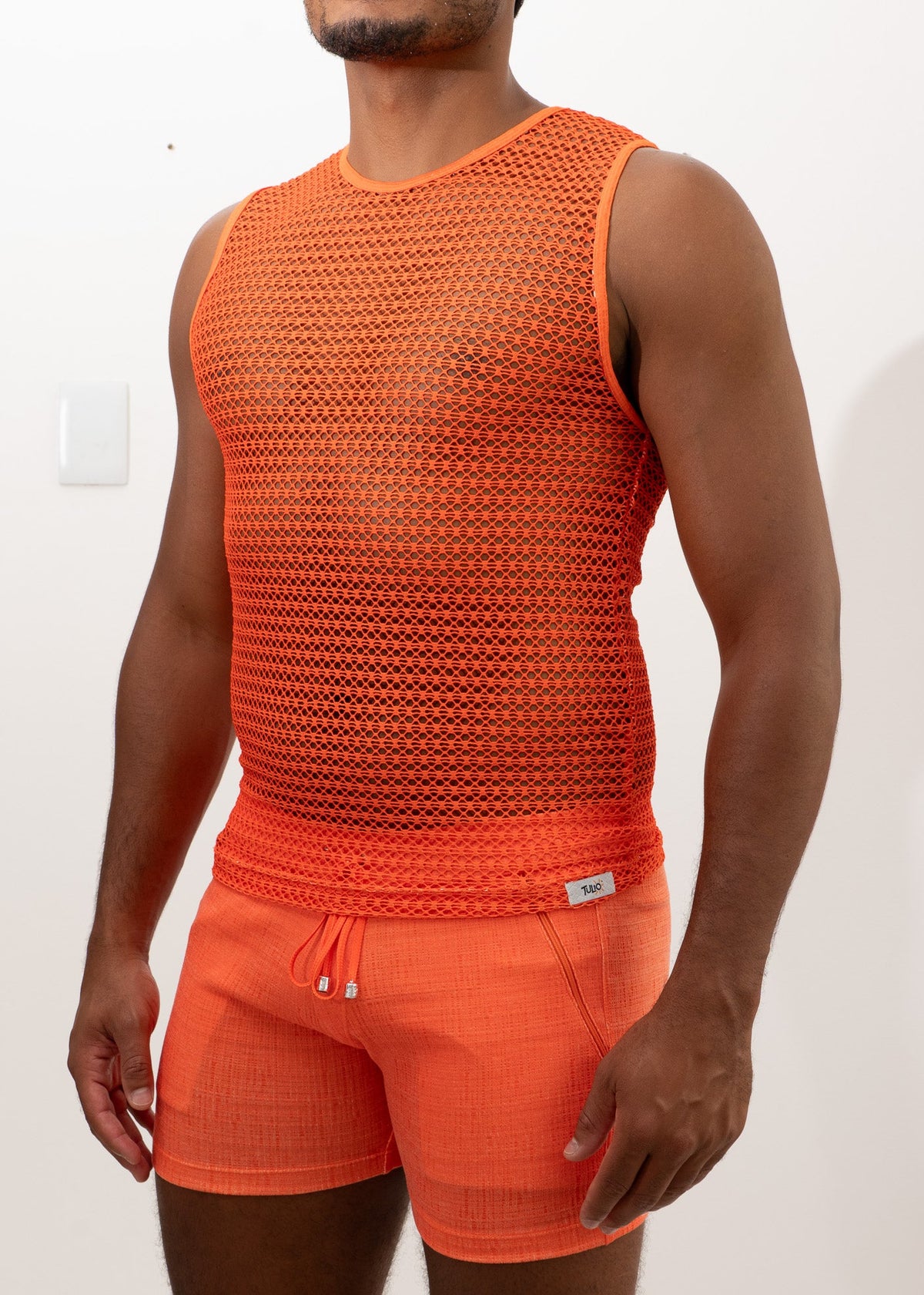 Orange crochet muscle tank top with round neckline sleeveless design and elastic waistband detail