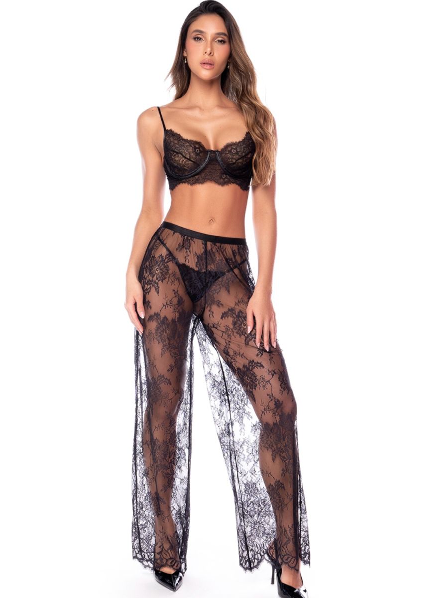 Model wearing a black 3-piece lingerie set with a lace bra, thong, and sheer wide-leg pants.