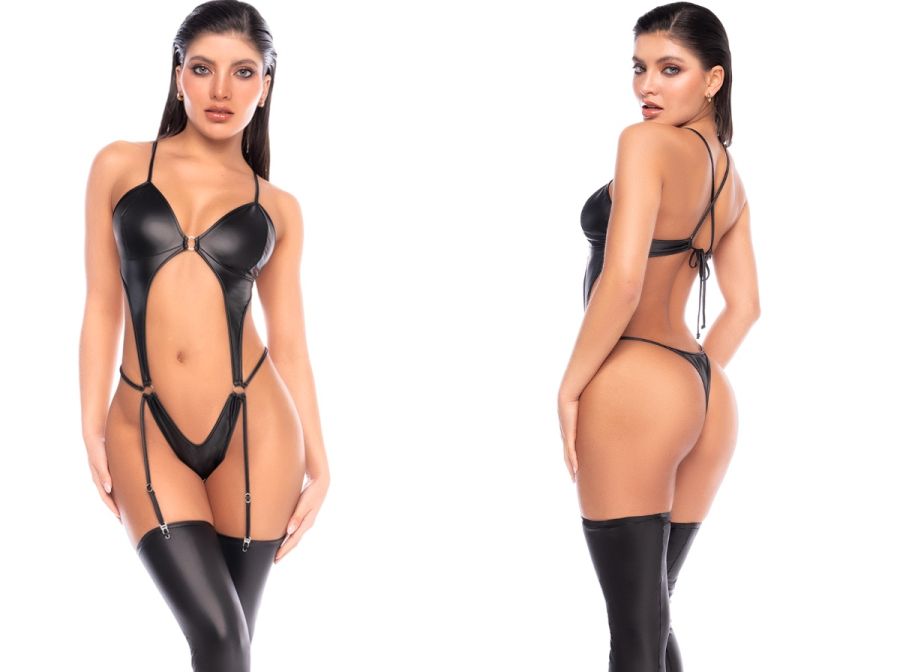 Black wet-look bodysuit with cutouts, rings, attached garter straps, thong back, and thigh-high stockings.