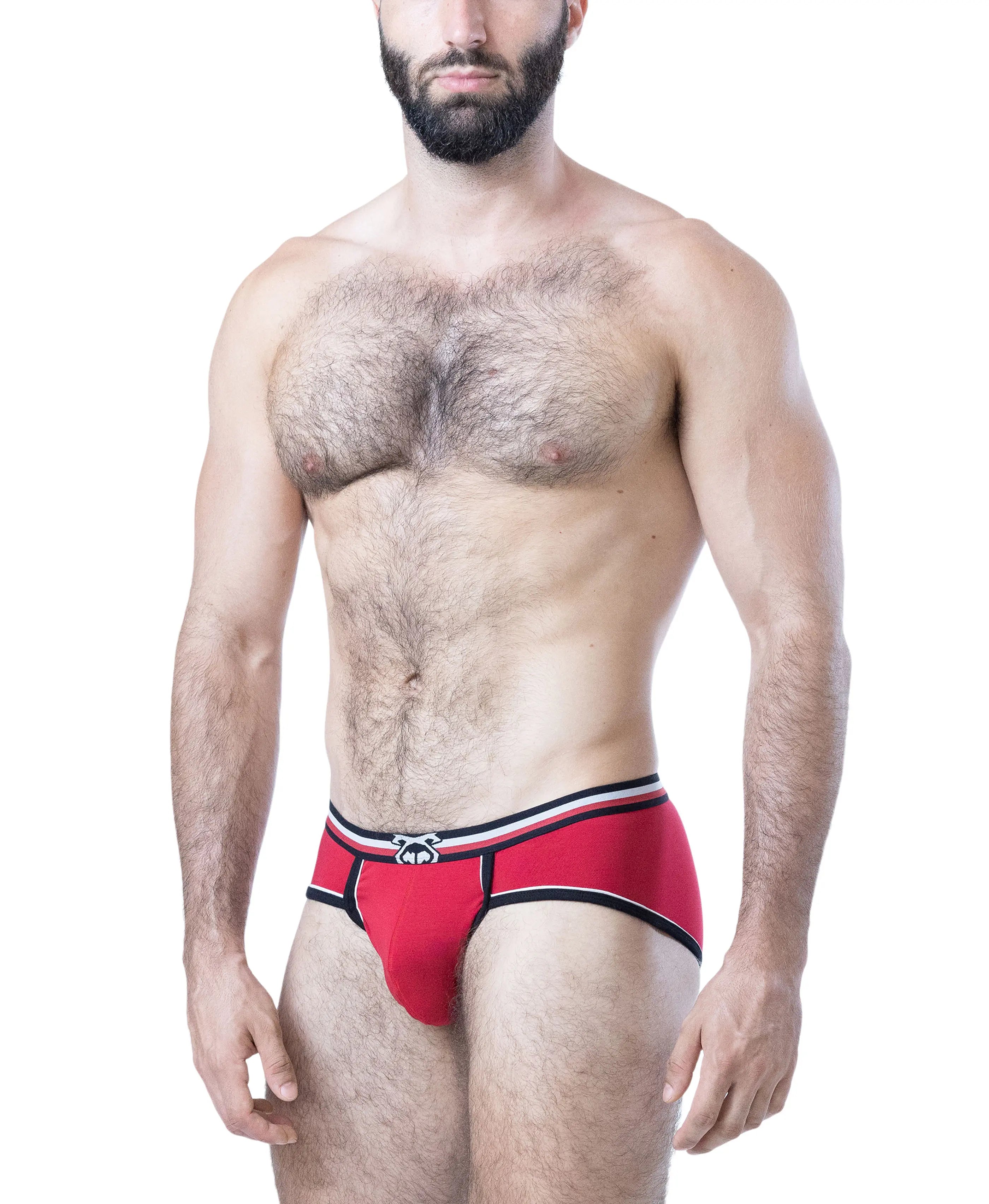 Male model wearing red U-front briefs with black and white trim and logo on waistband by Nasty Pig