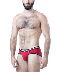 Male model wearing red U-front briefs with black and white trim and logo on waistband by Nasty Pig