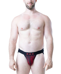 Male model wearing black and red flame-patterned jockstrap with XXX detail on waistband by Nasty Pig