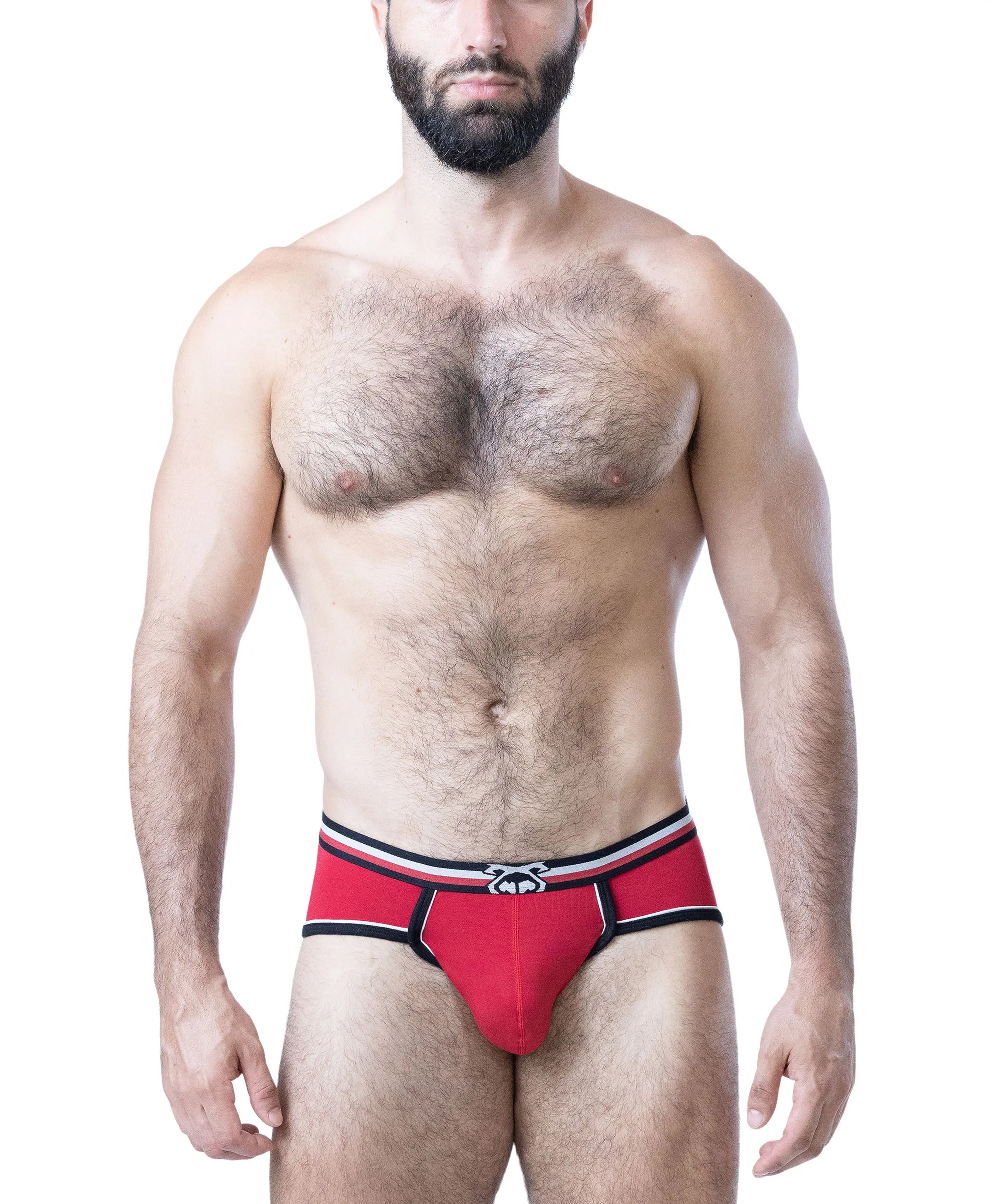 Male model wearing red cotton briefs with black and white trim and logo waistband by Nasty Pig