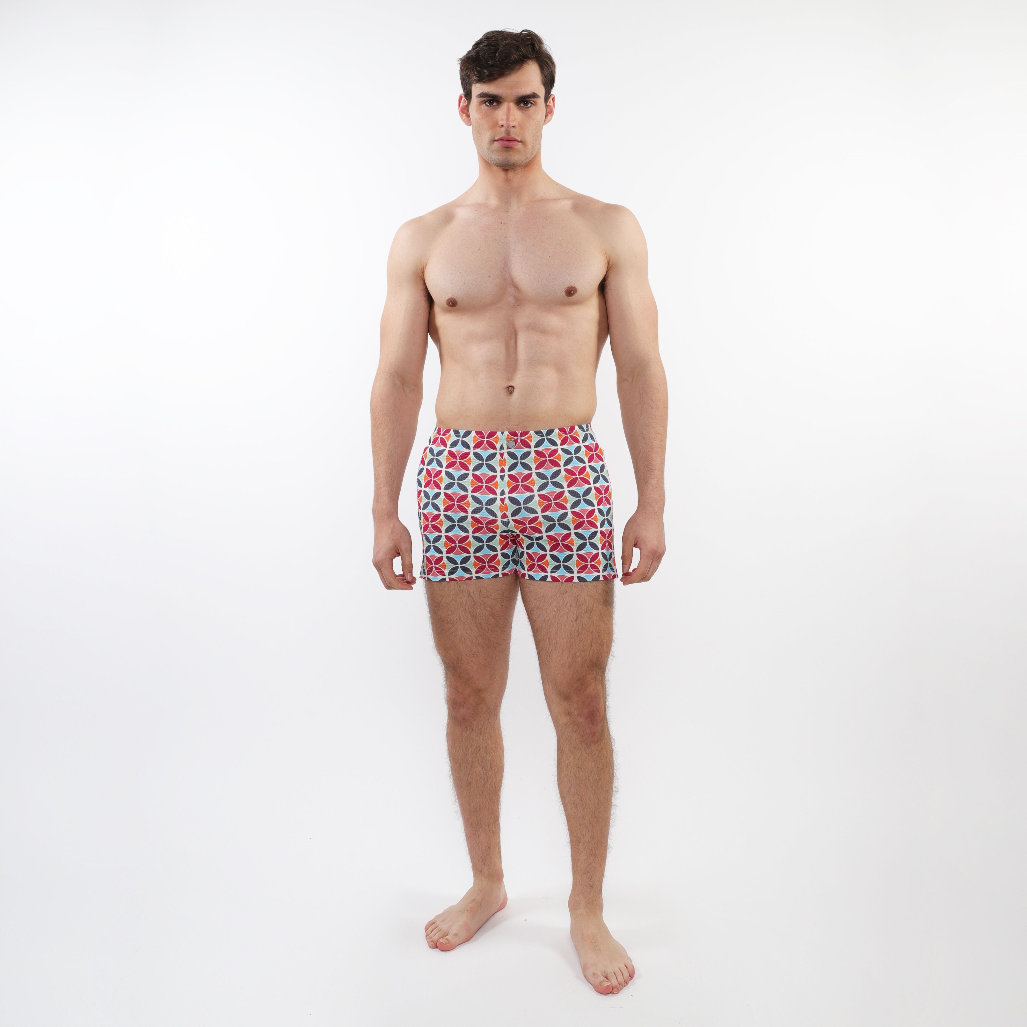 Seersucker swim shorts with mesh lining featuring vibrant red blue and white geometric patterned men’s swim trunks
