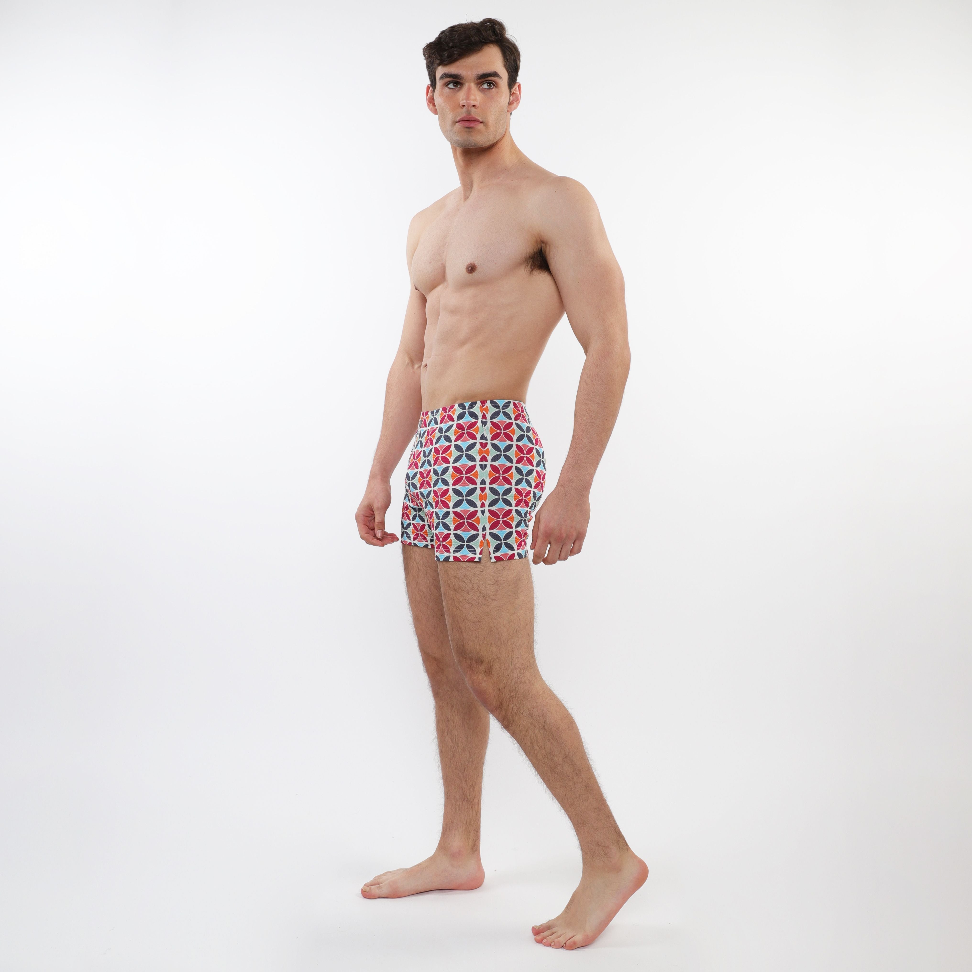 Men’s red blue and white geometric patterned seersucker swim shorts with mesh lining for comfortable swimming
