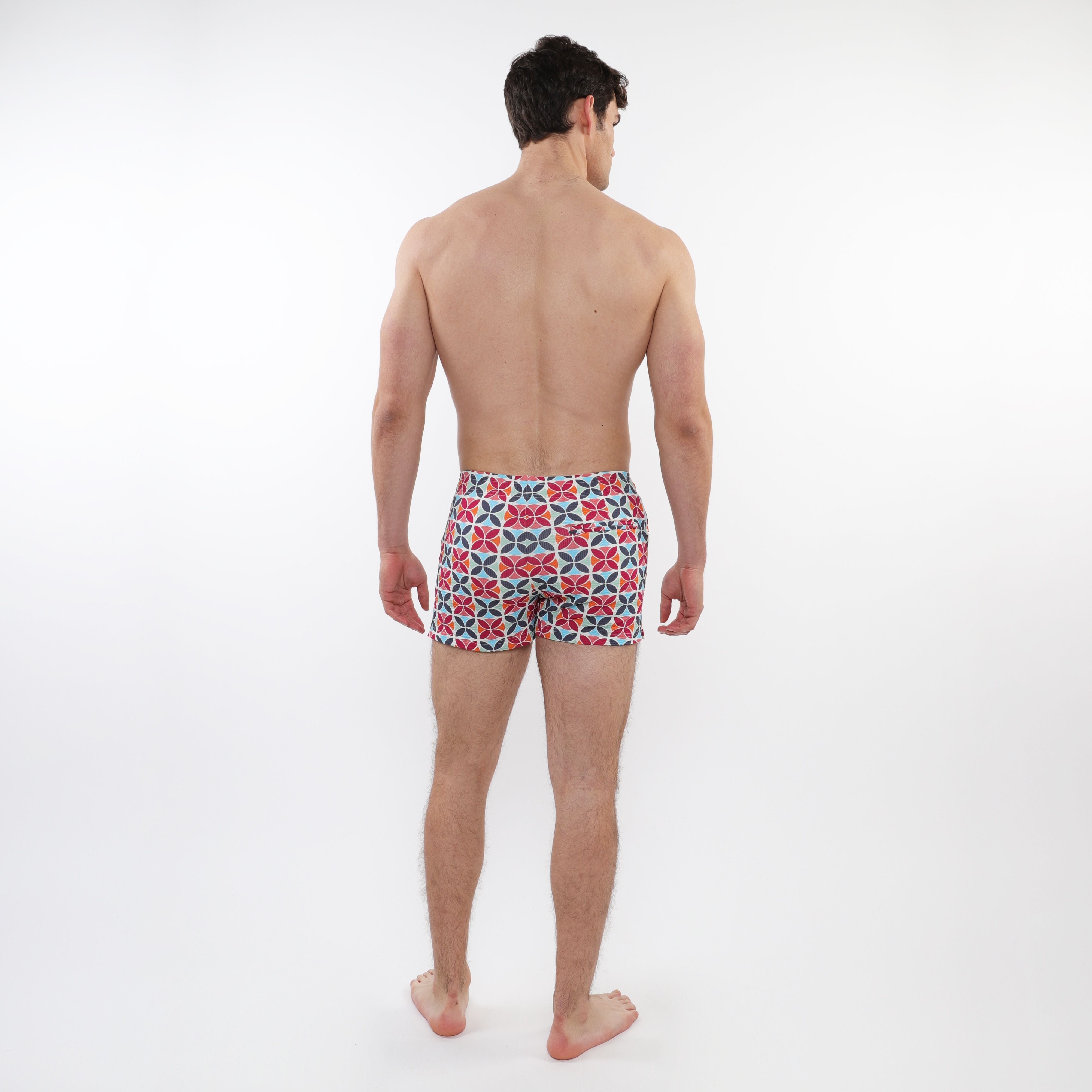 Men’s seersucker swim shorts with mesh lining featuring a bold red navy blue and white geometric pattern