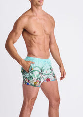 Light blue tropics print swim shorts with mesh lining featuring green leaves red flowers and colorful birds tropical design