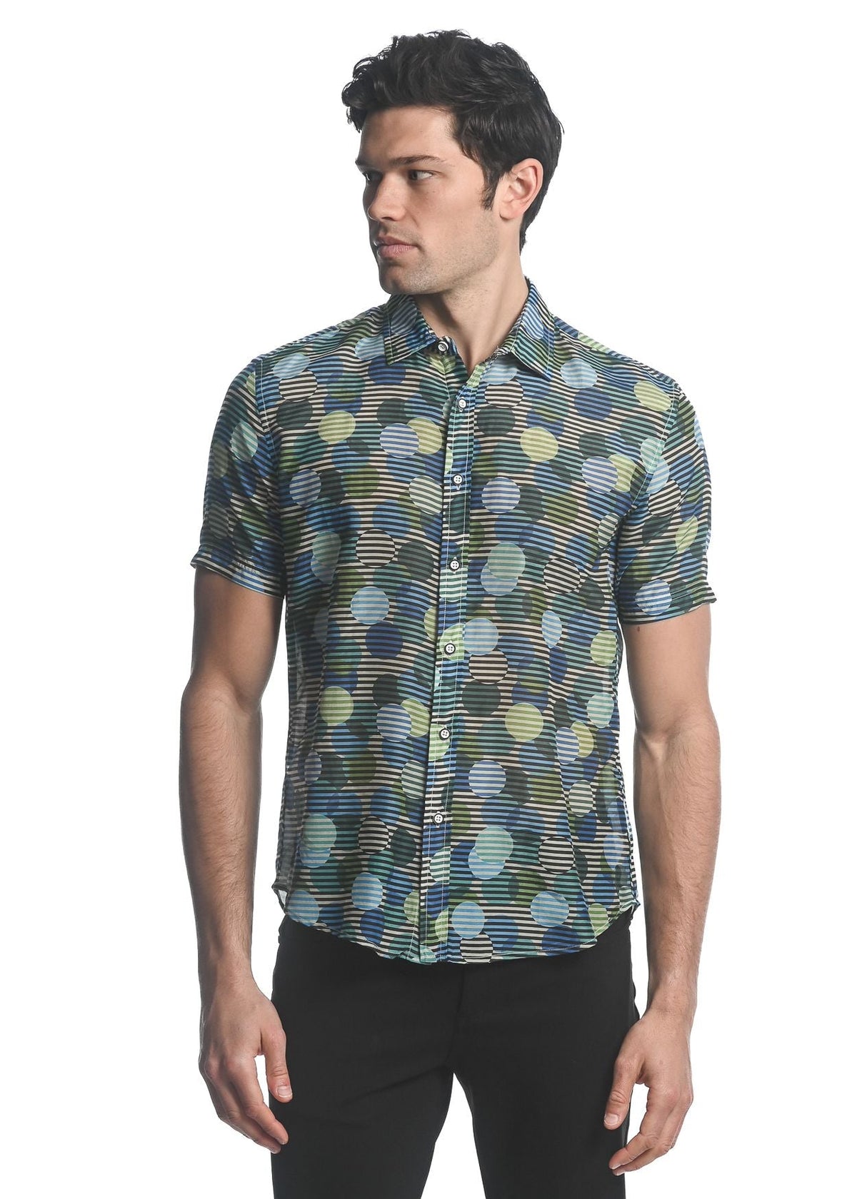 A men’s short-sleeved cotton silk shirt with vibrant green blue and yellow circle pattern on dark fabric