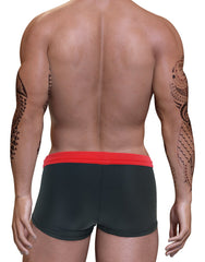 Back view of a muscular man with arm tattoos wearing black square-cut swim trunks with a contrasting red waistband.