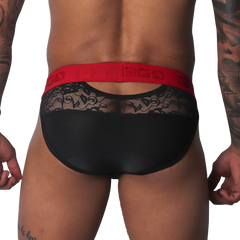 Black brief with sheer floral lace upper panel, solid black lower section, and a bold red branded elastic waistband.