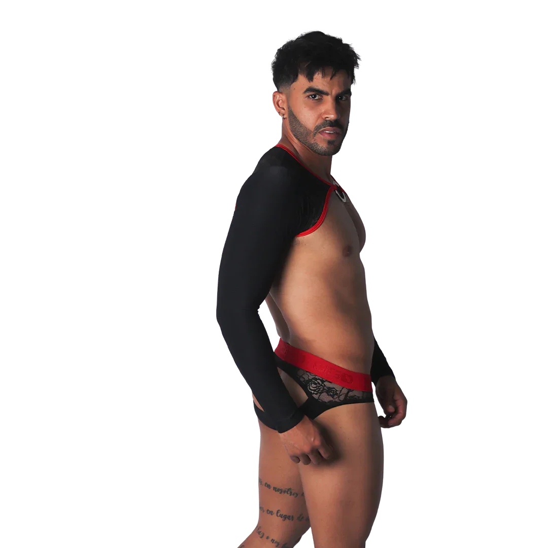 Black long-sleeved harness with red trim and O-ring, paired with matching red-waistband black lace briefs.