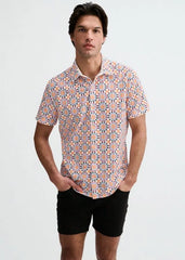 Man wearing ST33LE short-sleeve button-up shirt with colorful medallion print in orange purple and white paired with black shorts