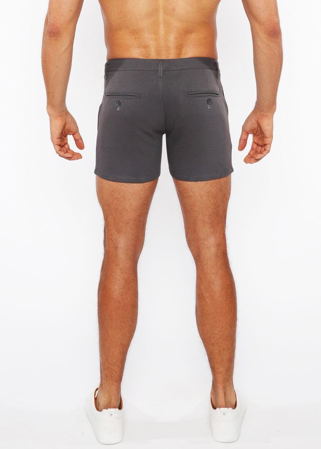 Dark gray linen-look textured tailored shorts with button back pockets and zip pockets shown from the back side