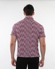 A man wearing a crinkle knit short sleeve shirt with a marled pink gray and white textured pattern