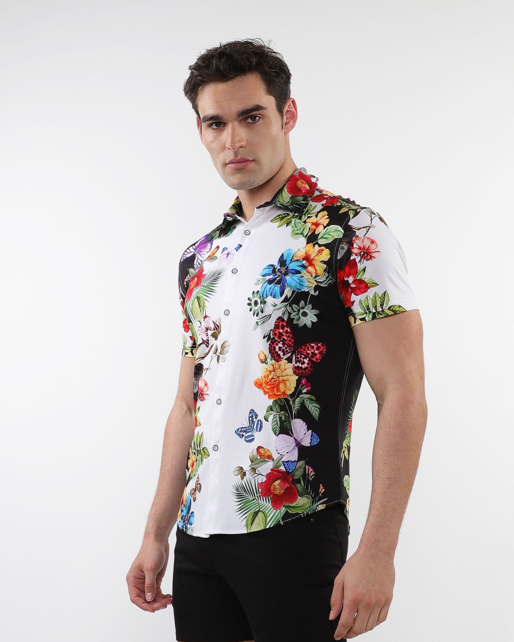 Floral border print stretch knit shirt with vibrant tropical floral and butterfly design on white and black background