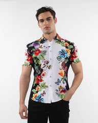 Floral border print stretch knit shirt featuring vibrant tropical short sleeves with bold floral and butterfly motifs on black and white