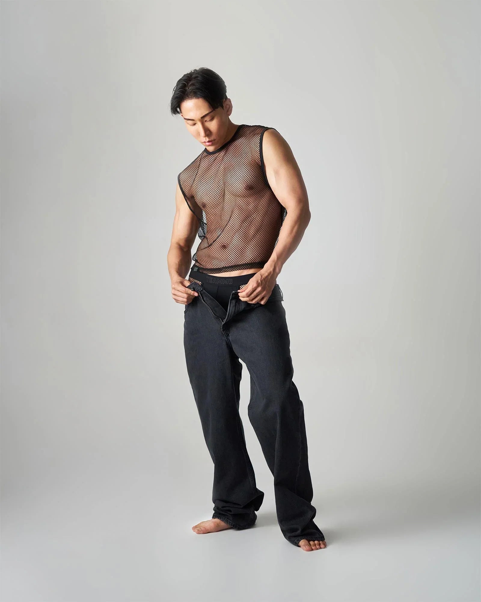 Black edge net mesh muscle tank with sheer semi-transparent design and breathable fabric for active wear