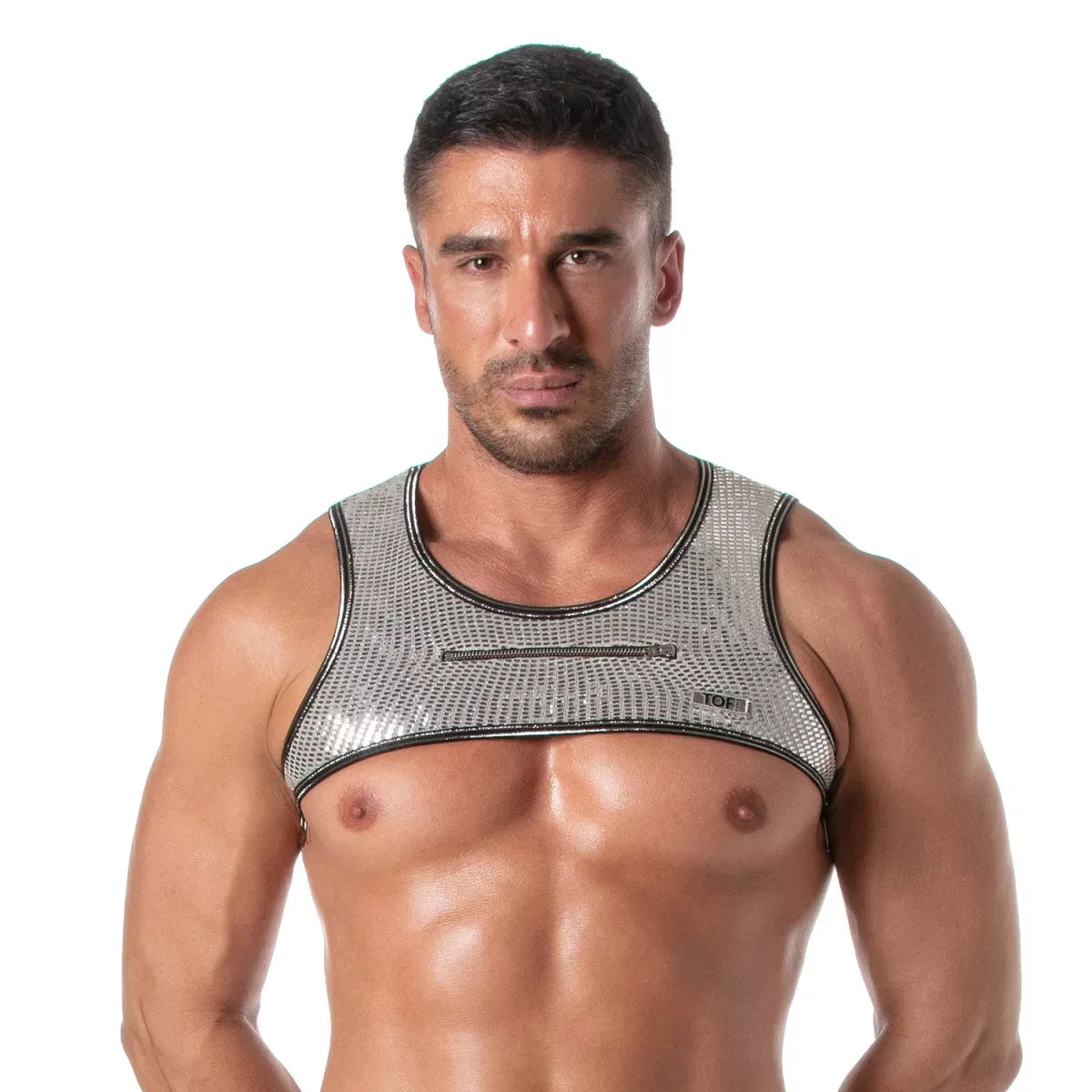 Male model wearing a silver glitter cropped harness with black trim and a small front zipper detail by TOF Paris