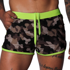 Short camouflage swim trunks with neon yellow elastic waistband, matching drawstring, and neon yellow piped trim.