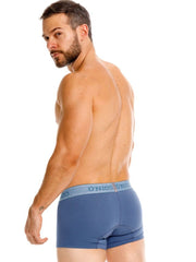 Unico 26040100117 classic trunks in teal with a light blue elastic waistband featuring the unico logo