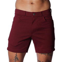 Wine-colored tailored shorts with a structured waistband, button closure, and classic five-pocket design.