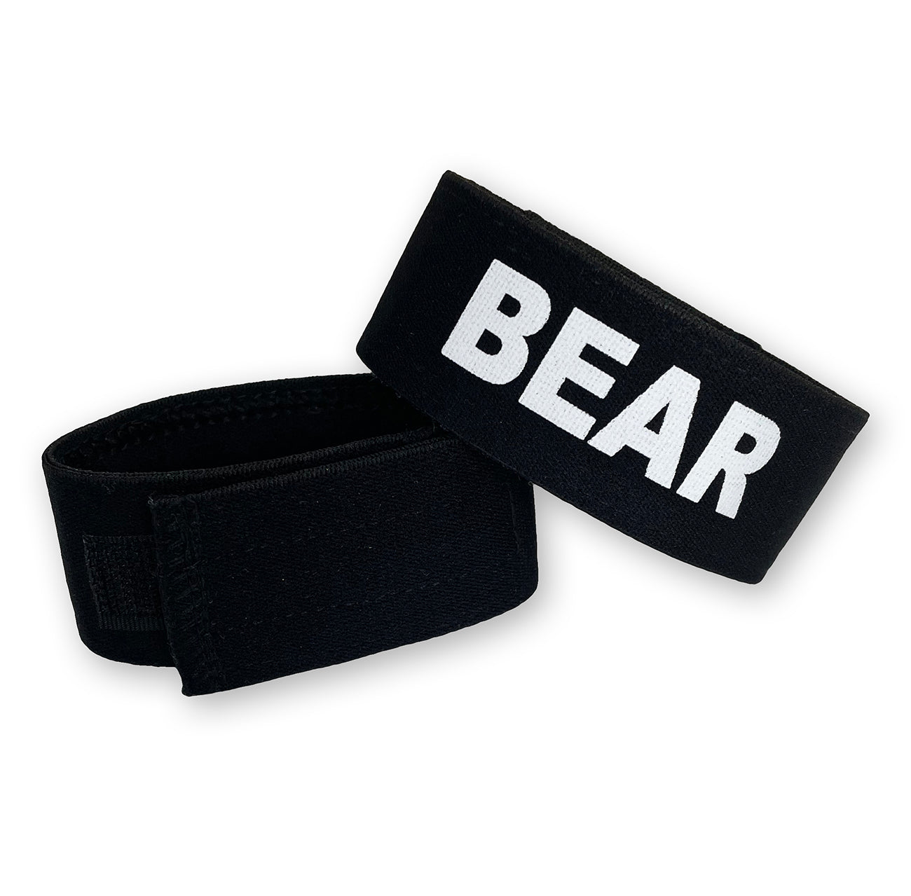 Two black, adjustable velcro cock-rings with the word "BEAR" printed in bold white letters on the fabric.