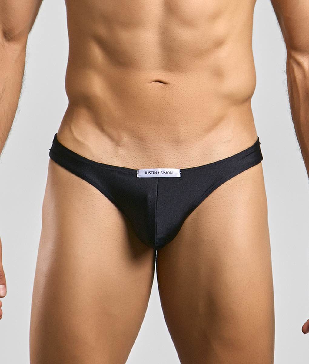 Black justin simon classic mens bikini briefs with a sleek form-fitting design and subtle brand tag at the waistband