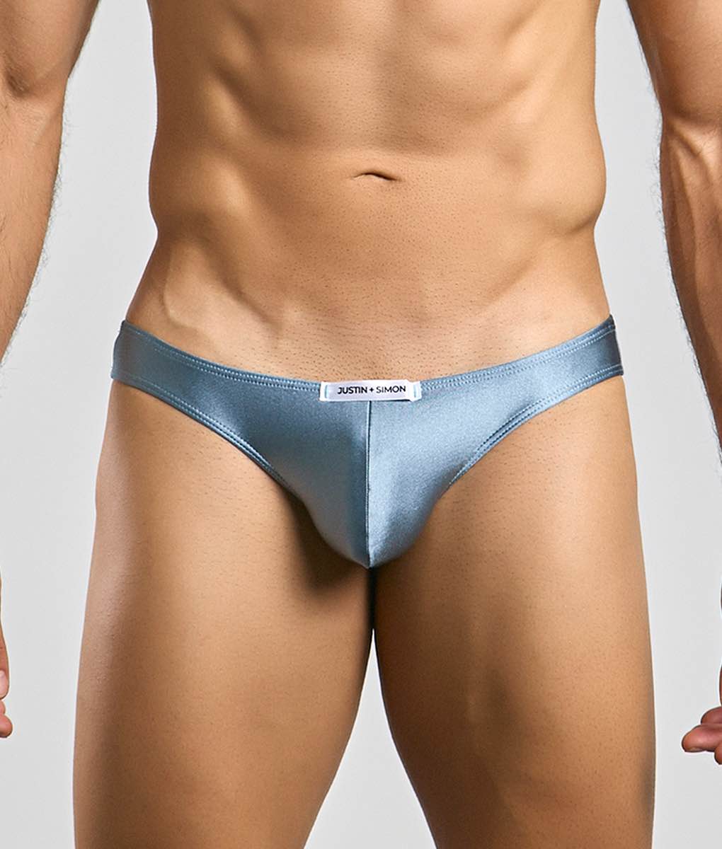 Justin + Simon classic mens bikini light blue satin briefs with sleek form-fitting design and white brand tag at waistband